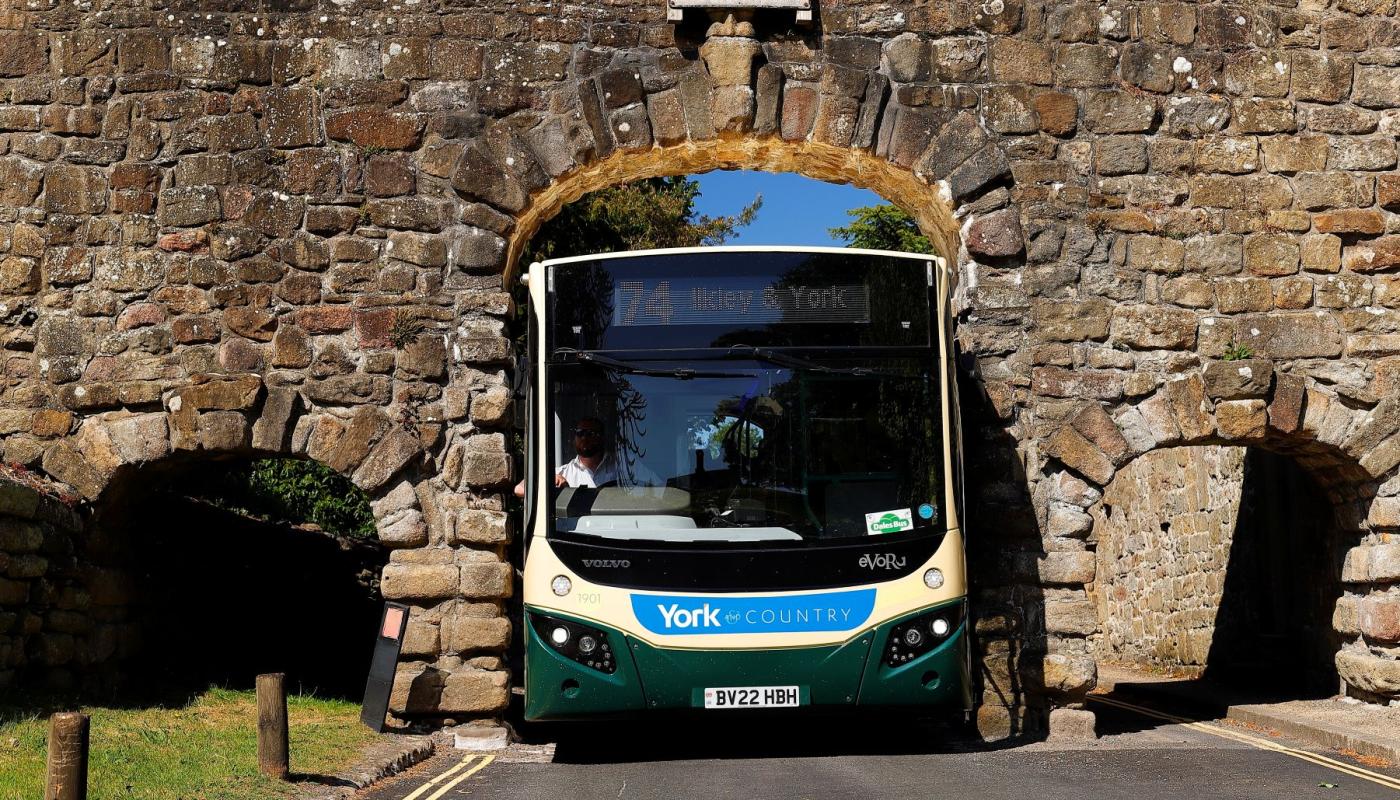 Transdev driver Wayne Moody calmly guides his bus through Yorkshire’s Bolton Abbey arch – just 9 ft 5 inches wide – as images of him completing the task without a scratch go viral on social media