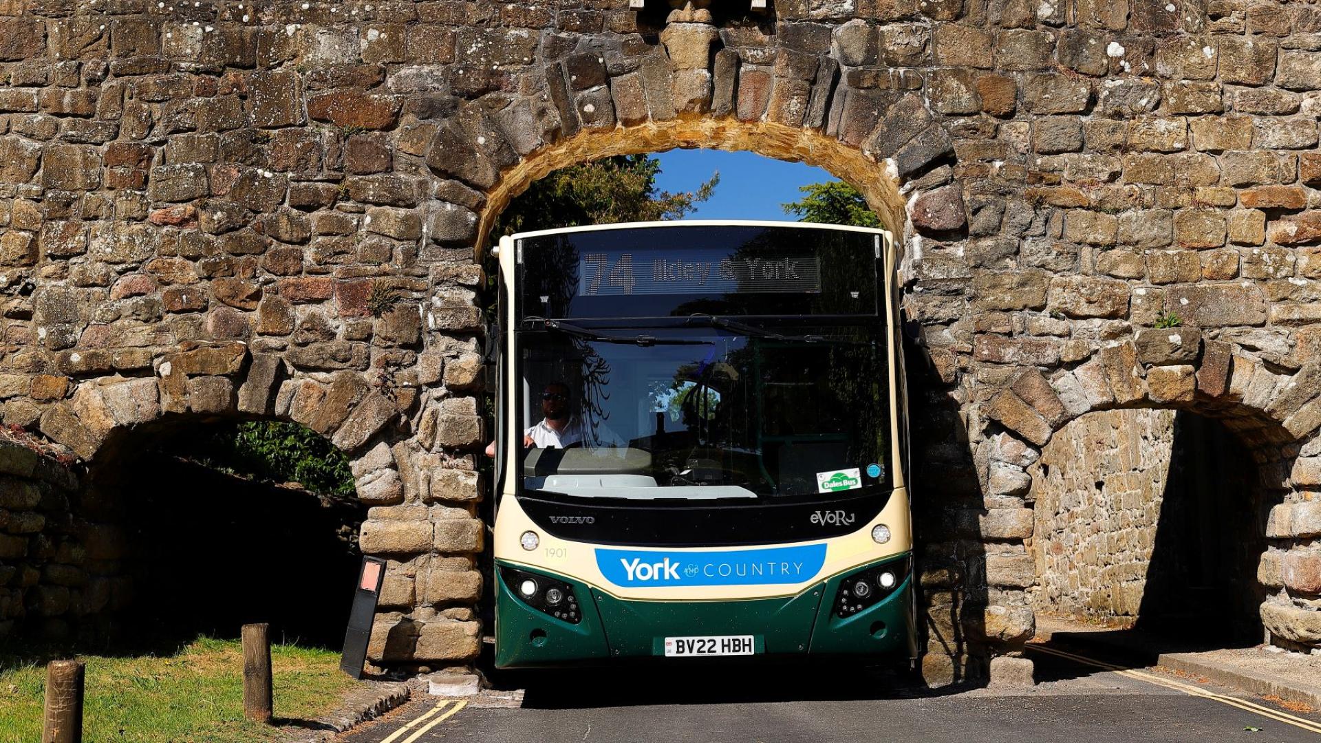 Transdev driver Wayne Moody calmly guides his bus through Yorkshire’s Bolton Abbey arch – just 9 ft 5 inches wide – as images of him completing the task without a scratch go viral on social media