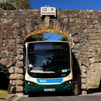 Transdev driver Wayne Moody calmly guides his bus through Yorkshire’s Bolton Abbey arch – just 9 ft 5 inches wide – as images of him completing the task without a scratch go viral on social media