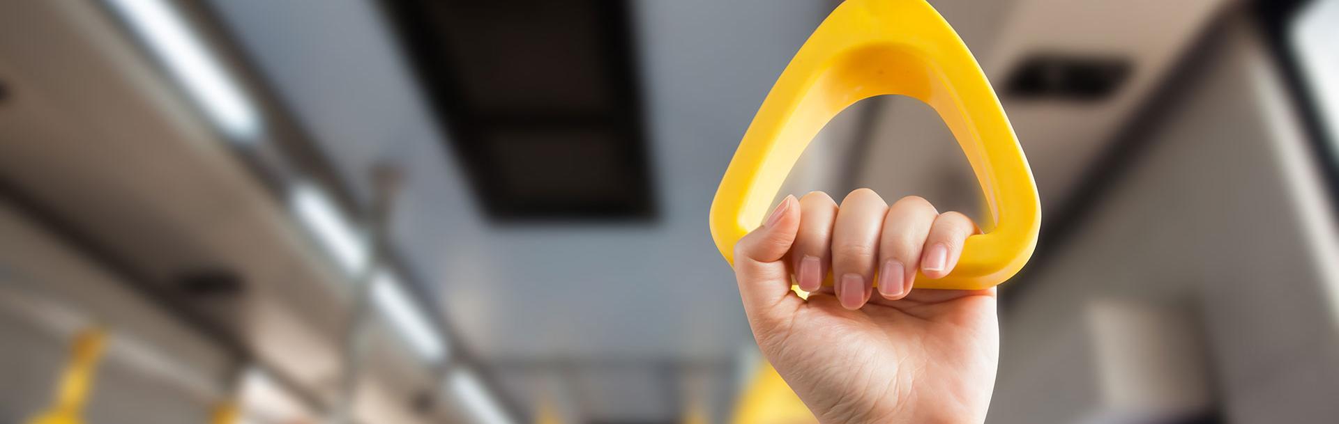 A hand holding the bus