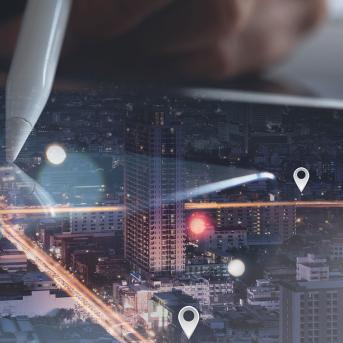 A pen on a map with a city landscape