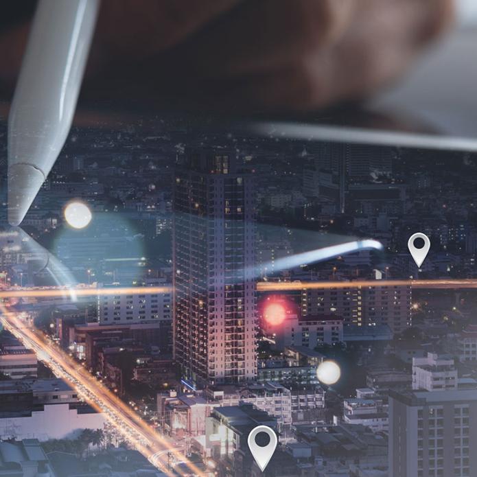 A pen on a map with a city landscape