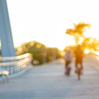 people on bicycles on a bridge