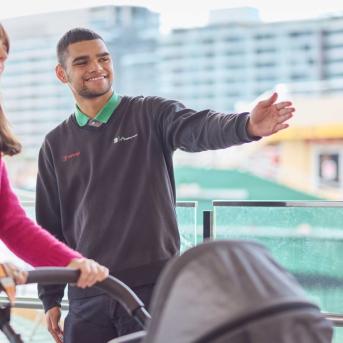 Woman pushing a pram asking for directions