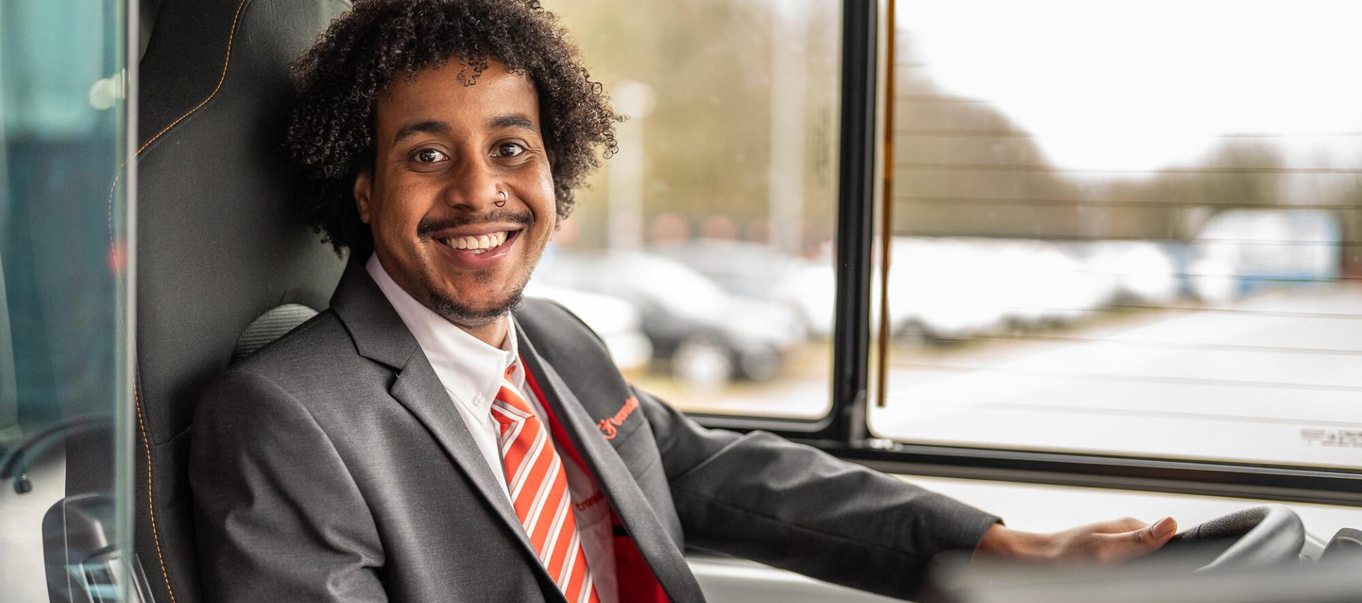 Netherlands - Bus Driver wearing a shirt and tie smiling