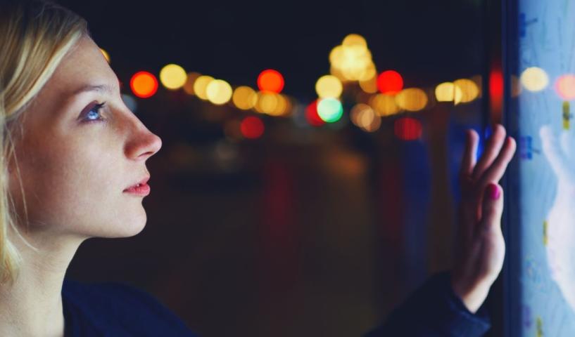 Femme blonde qui clique sur une carte interactive affichée sur un écran