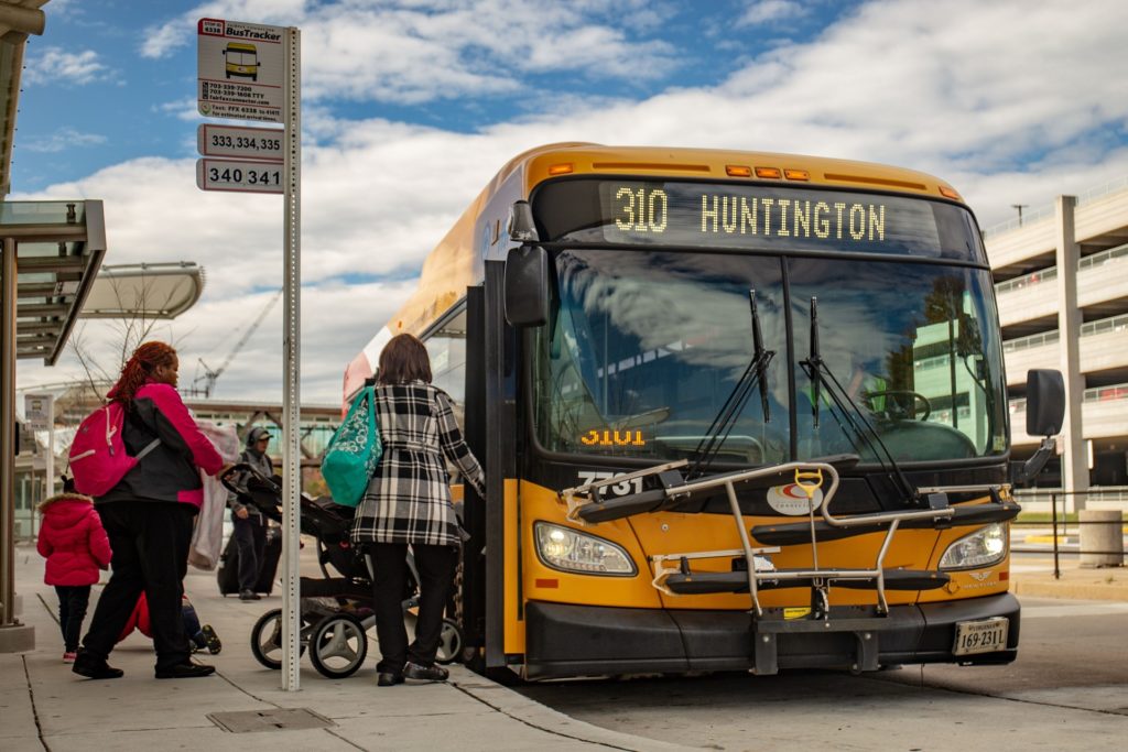 passengers yellow bus Fairfax connector county Transdev north america public transit mobility