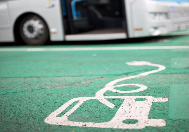 green parking space for electric bus with a blurred bus in the background