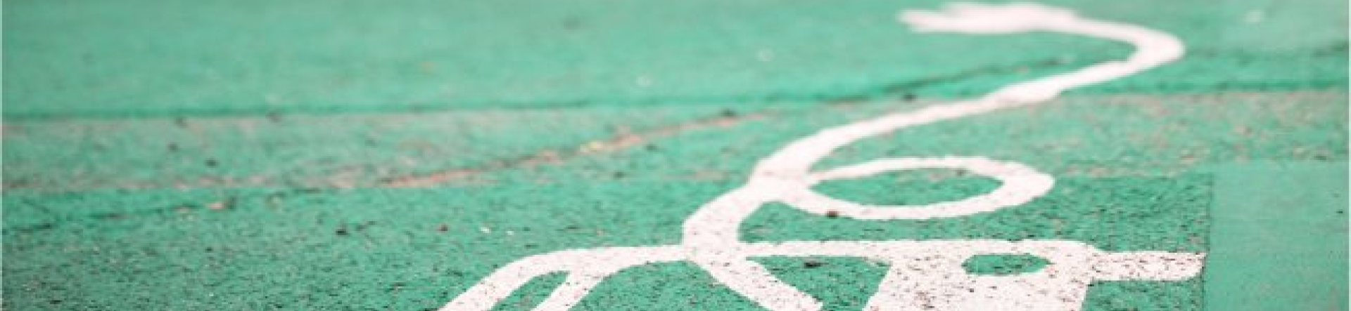 green parking space for electric bus with a blurred bus in the background