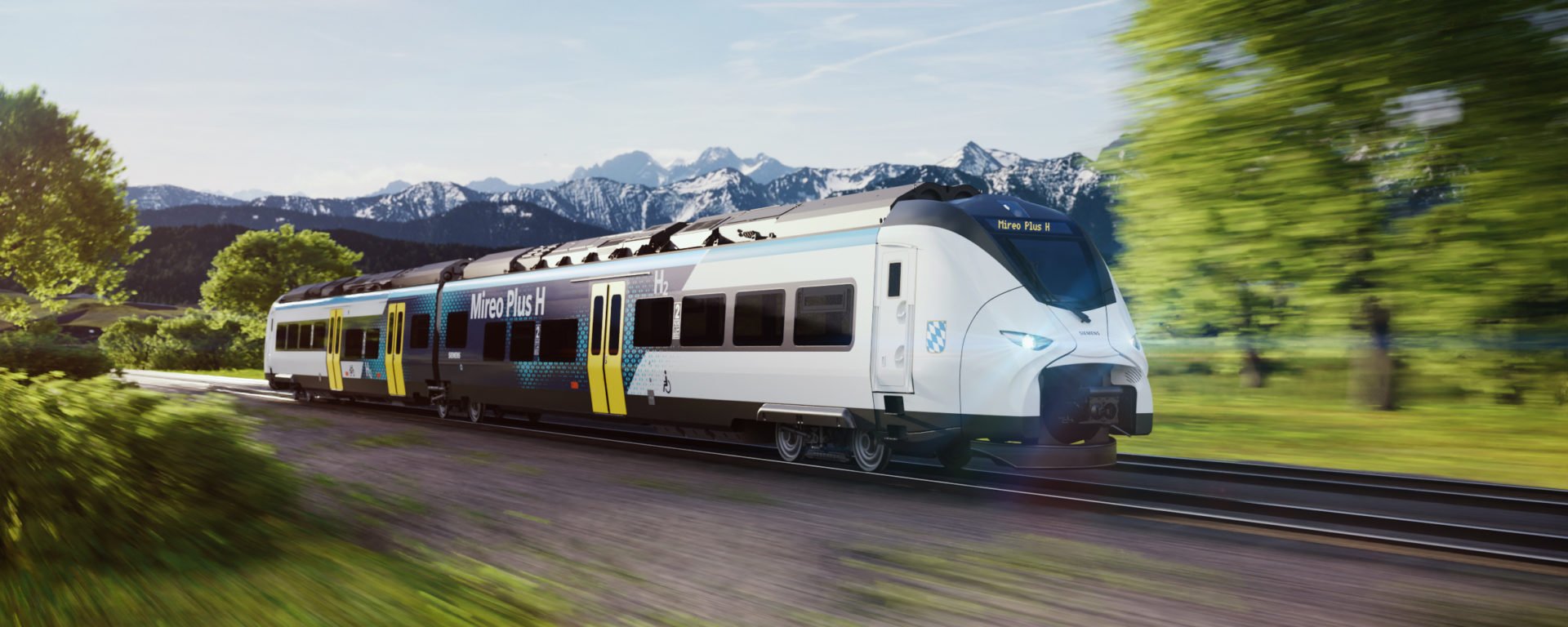 train hydrogène roulant à toute vitesse en arrière plan des montagnes neigeuses