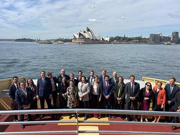 Sydney Harbor Ferries team and French trade delegation on teh deck of a ferry