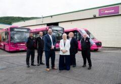 West Yorkshire Mayor and a group of people standing in front of pink buses inaugurates Team Pennine new depot