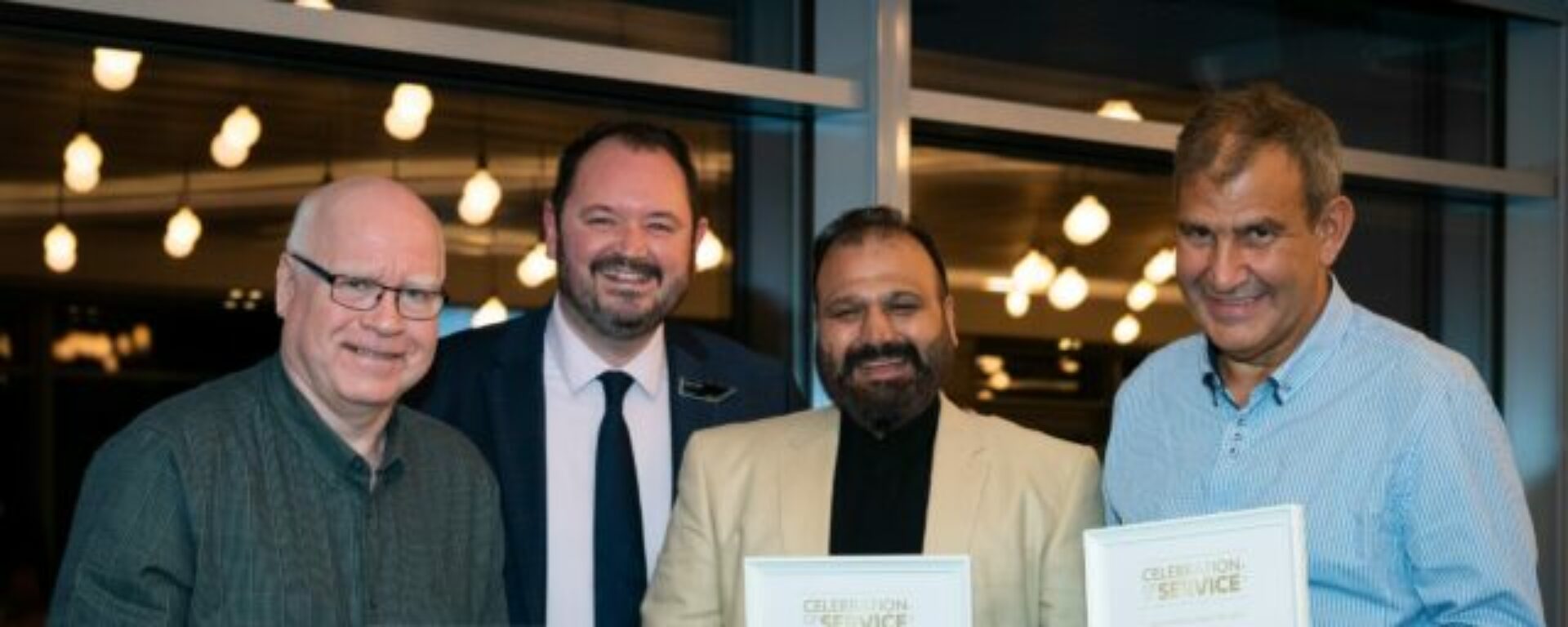 Picture Shows: The three longest-serving members of Transdev’s teams in Keighley, Burnley, and Blackburn have each completed 45 years’ service. Pictured from left: Michael Boyes, Driver, The Blackburn Bus Company; Transdev CEO Alex Hornby; Shabir Ahmed, Duty Manager, The Keighley Bus Company; and Alex Pomponi, Driver, The Burnley Bus Company.