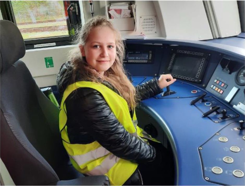 Young girl pretending to drive a train